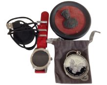 A Montblanc Summit smart watch with charger together with a miniature relief plaque of Montgomery