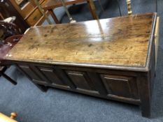 A George III oak panelled coffer on raised legs,