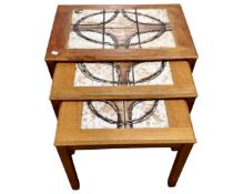 A nest of three tiled topped tables together with teak effect occasional table