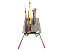 A wheelbarrow containing garden tools.