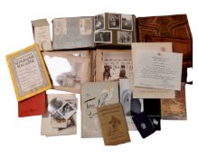 A crate of monochrome photograph albums, tooled leather bags,