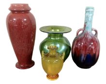 A tray containing a Bretby vase together with two further glazed pottery vases and an iridescent