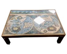 A brass bound coffee table depicting a map of the world
