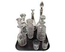 A tray containing six cut glass and lead crystal decanters together with a further pair of whiskey