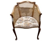 A mahogany and bergere tub armchair