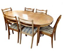 A 20th century S Form teak oval extending dining table together with six chairs