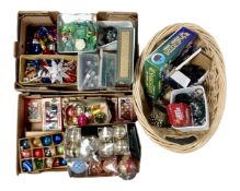 Two boxes and a basket containing a quantity of vintage and later Christmas decorations and lights.