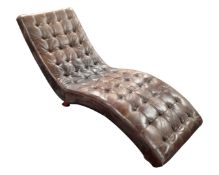 A contemporary brown leather chaise longue