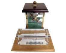 A large glass paperweight 'Flying Scotsman' on wooden stand together with a model of Spitfire in