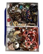 Two boxes containing a quantity of assorted costume jewellery.