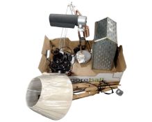 A box containing contemporary angle poise table lamps,