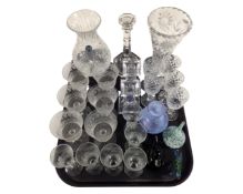 A tray containing assorted glassware including drinking glasses, glass paperweights,