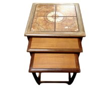 A nest of three 20th century teak G-plan tables (one with tiled top)
