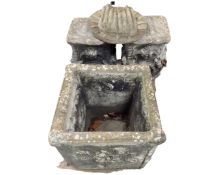 A pair of concrete garden pedestals together with a square planter and sun wall plaque