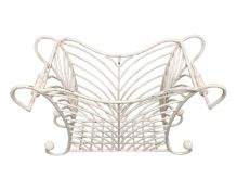 A painted wrought iron magazine rack