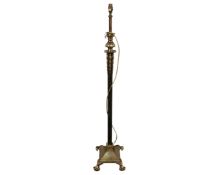 An antique heavy cast brass standard lamp