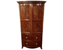 A Victorian style mahogany double door bow fronted cabinet fitted internal shelves