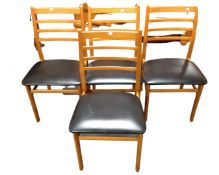 A set of four 20th century ladder backed chairs with black vinyl seats
