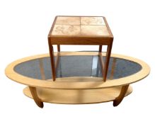 A 20th century teak tiled topped occasional table together with a further oval glass topped table