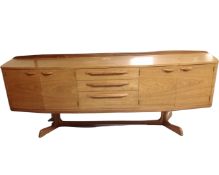 A 20th century Chapmans Siesta teak bow fronted teak four door sideboard fitted with three central