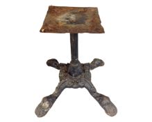 An antique cast iron four way table pedestal.