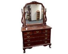 A Georgian style mahogany six drawer dressing chest on claw and ball feet