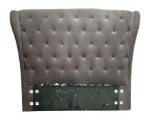 A 6' bed head upholstered in buttoned fabric