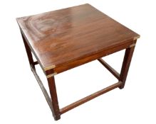 A square lamp table in a mahogany finish, with brass mounts.