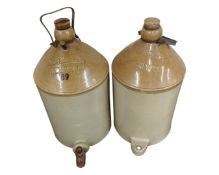 Two large pottery flagons marked R. A. Canteen Woolwich, one with tap.