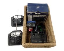 A basket containing a First Act practice amplifier, Futaba and Sanwa radio control handsets,