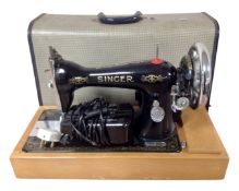 A vintage 20th century Singer electric sewing machine in case.