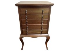 An Edwardian mahogany five drawer music chest on cabriole legs.