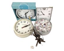 A box containing industrial style table lamp, a boxed tea set, wall clocks.