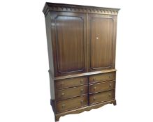 A Reprodux mahogany Georgian style linen press fitted with drawers beneath.