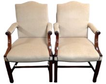 A pair of George III style mahogany armchairs upholstered in a dralon fabric.