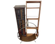 A contemporary wall rack together with a cupboard in the form of bookshelves and a metal magazine