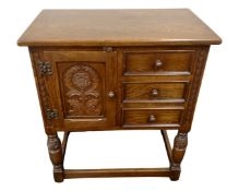 A Jaycee Furniture oak cabinet fitted with three drawers, on raised legs.