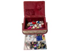 A fabric upholstered sewing box with contents.