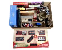 A box containing board games, dominoes, plastic animals, trophies, die cast cars,