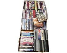 Two boxes containing a quantity of DVDs and DVD box sets including children's movies.