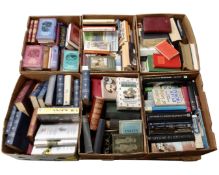 A pallet containing six boxes of hard and soft cover books including novels, Charles Dickens,