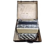 A Hohner Sirena accordion in case.