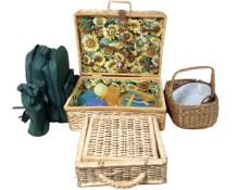 A picnic backpack together with two wicker picnic baskets and two further wicker hand baskets.