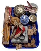 A tray containing Oriental pieces including wooden figures, soup bowls with spoons, a napkin ring,
