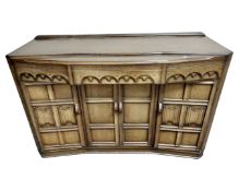 An oak linen fold sideboard.