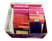 A box containing Ordnance Survey and Bartholomew folded maps.