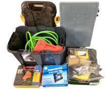 A storage box containing a Silverline stapler, air hose,