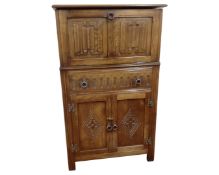 A Jaycee Furniture oak linen fold cocktail cabinet.