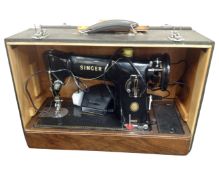 A 20th century Singer electric sewing machine in case.