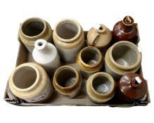 A box containing a collection of vintage kitchen storage jars and bottles.
